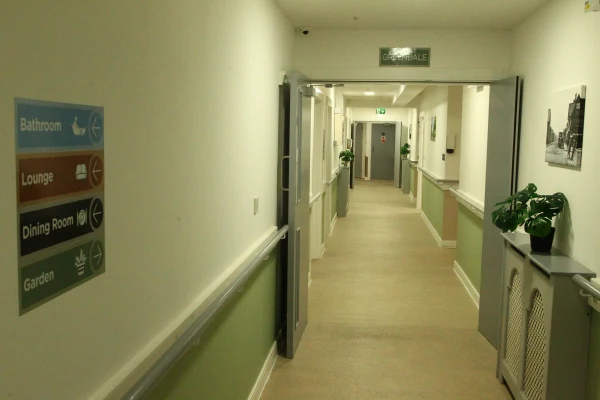 Accessible corridor with clear signage at Chestnut Rise Nursing Home